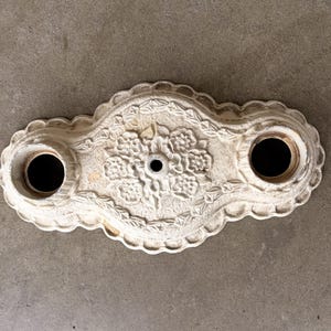 May include: A set of three ceramic mugs with a speckled, matte finish. The mugs are in shades of cream, light gray, and dark gray. Each mug has a simple, minimalist design and a rounded handle. The mugs are stacked on top of each other.
