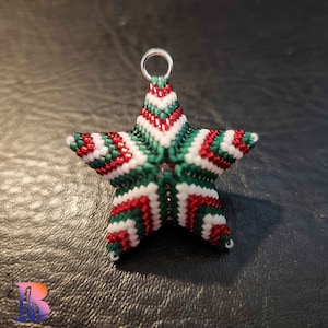 May include: A red, white, and green beaded star ornament. The star is 3-dimensional and has a loop at the top for hanging.