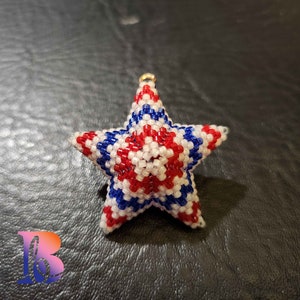 May include: A red, white, and blue beaded star ornament with a gold loop for hanging.