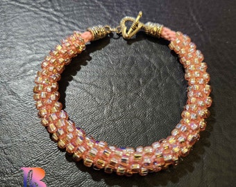 9" pink beaded kumihimo bracelet with heart toggle closure