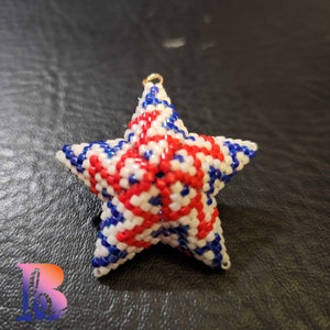 May include: A red, white, and blue beaded star ornament with a gold loop for hanging.