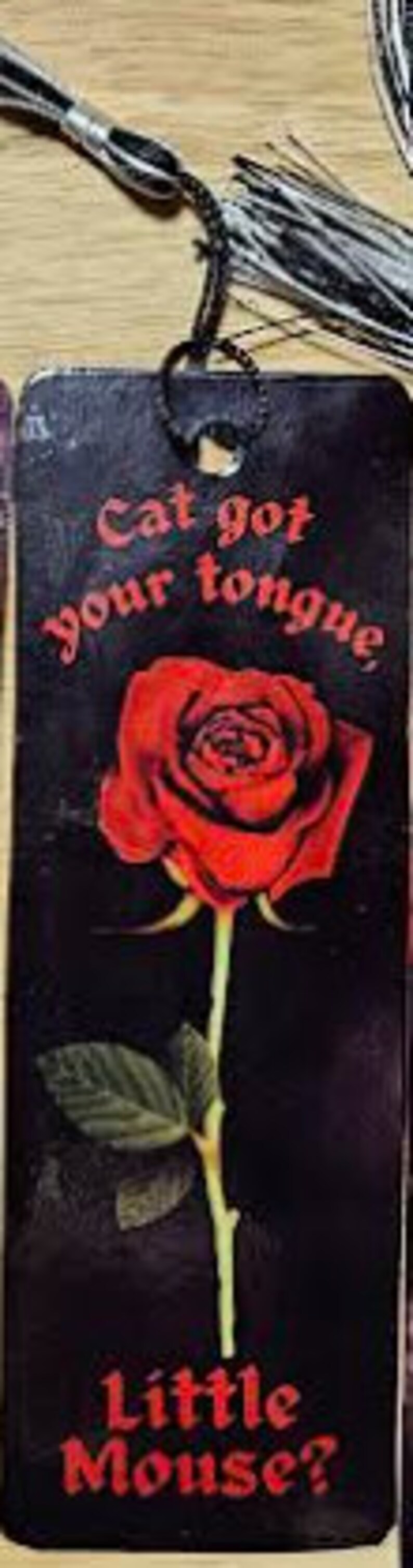 May include: Black bookmark with a red rose and the text "Cat got your tongue, Little Mouse?"