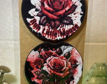 May include: Two round car coasters with a black background and red roses. The top coaster has the text "My Little Mouse" and the bottom coaster has the text "Mischief".