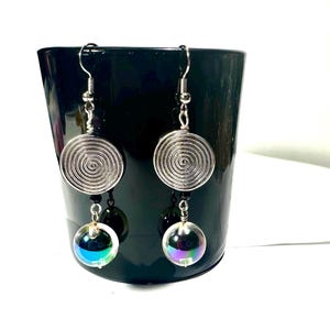 May include: Silver earrings with a spiral design and iridescent glass beads.