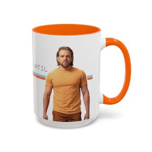 May include: White ceramic mug with an orange interior and handle. The mug features a photo of a person wearing an orange shirt. The word "UNTIL" is printed on the mug with a blue and orange stripe design.