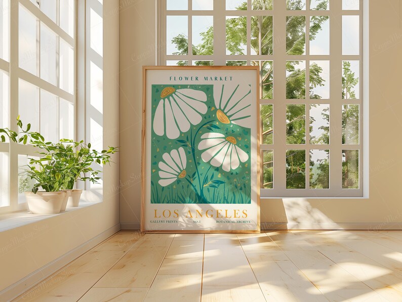 May include: A framed poster with a green background and white flowers. The poster says "Flower Market Los Angeles" and "Botanical Archive" at the bottom.