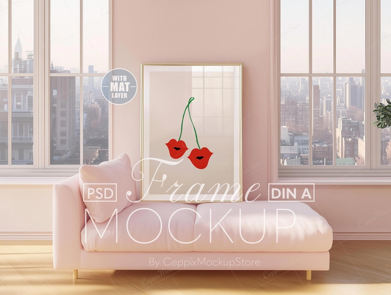 May include: A framed art print featuring a pair of red lips with green stems, displayed on a light beige background. The artwork is set in a gold frame and rests on a pink sofa. The words "Frame Mockup" are visible.
