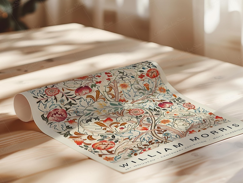 May include: Rolled poster featuring a floral design with red, orange, and blue flowers, and green leaves. The poster has the text "WILLIAM MORRIS" and "ART NOUVEAU - CENTENARY EXHIBITION - MOTIF CLASSIQUE". The poster is on a wooden surface.
