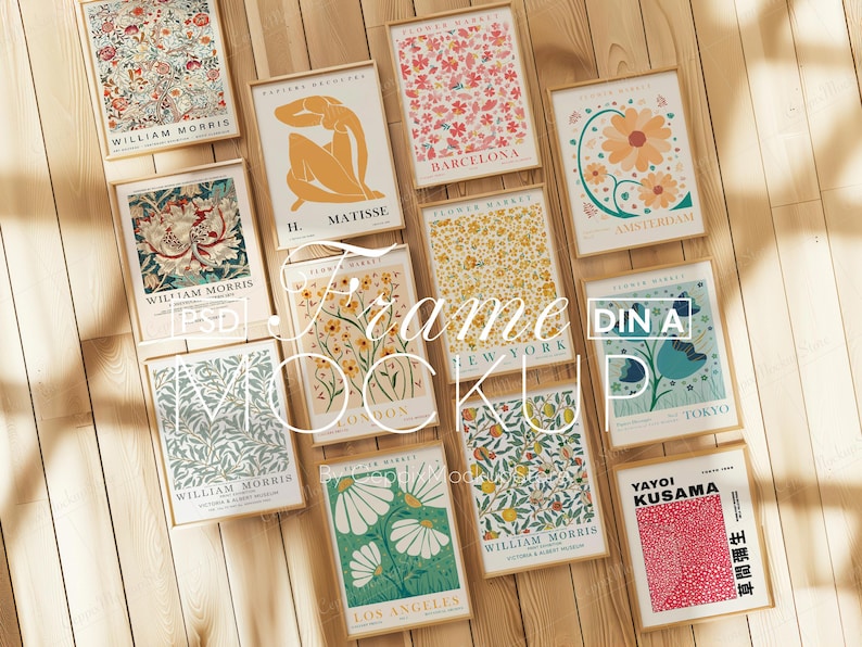May include: A collection of framed art prints featuring floral and abstract designs. The prints include text such as "William Morris", "Matisse", and city names like "Barcelona" and "Amsterdam". The frames are displayed on a wooden surface.