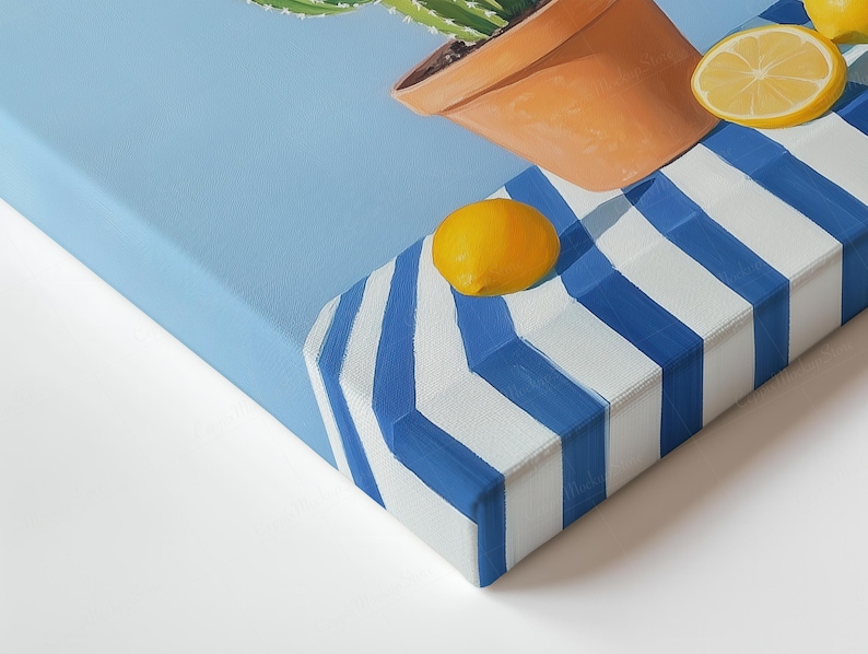 May include: A canvas art print showing a cactus in a terracotta pot, with lemons on a blue and white striped surface. The artwork has a bright, summery feel, with a light blue background.