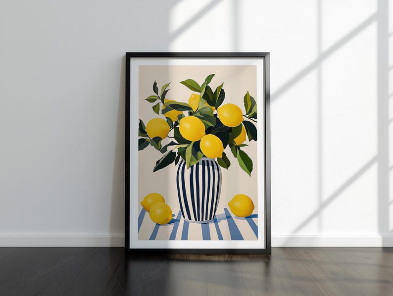 May include: A framed art print depicting a still life of lemons. The lemons are yellow and are in a black and white striped vase. The vase is on a blue and white striped surface. The print is in a black frame.