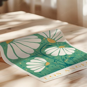 May include: A rolled-up poster featuring a botanical illustration of large white daisies with yellow centers against a teal green background. The poster includes the text "LOS ANGELES BOTANICAL ARCHIVES" in a golden yellow font.