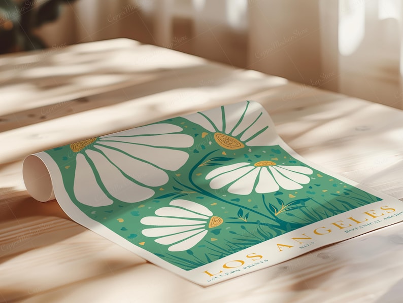 May include: A rolled-up poster featuring a botanical illustration of large white daisies with yellow centers against a teal green background. The poster includes the text "LOS ANGELES BOTANICAL ARCHIVES" in a golden yellow font.