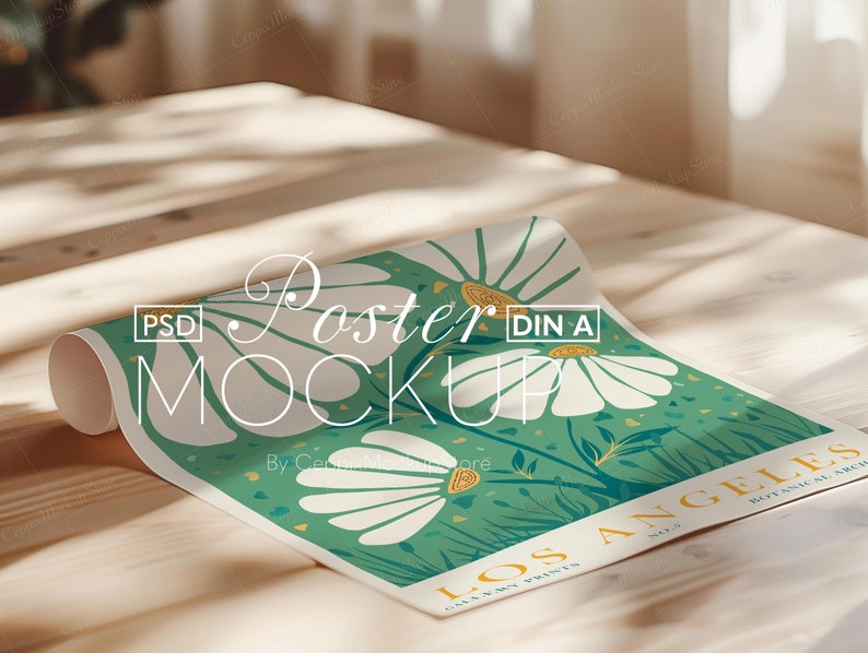 May include: Rolled poster mockup featuring a floral design with large white daisies on a green background. The poster includes the text "LOS ANGELES BOTANICAL ARCH" and "Poster MOCKUP". The poster is displayed on a wooden surface.