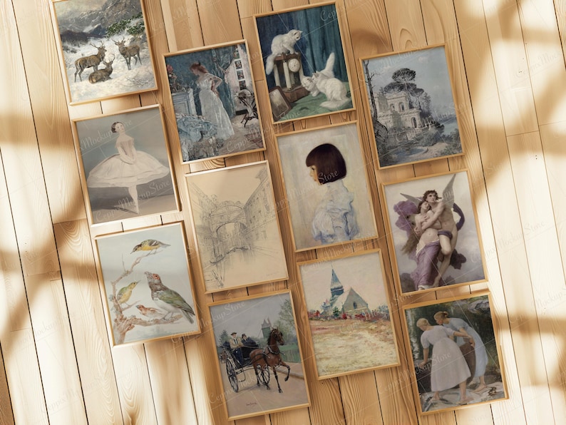 May include: A collection of framed vintage art prints. The prints feature various scenes, including landscapes with deer, portraits, and classical figures. The frames are a light wood color, and the prints are displayed on a wooden surface.