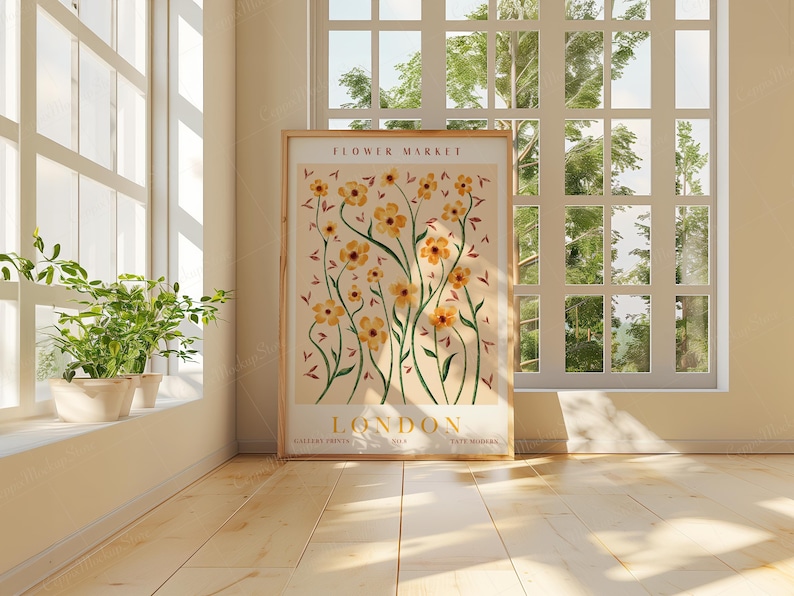 May include: A framed poster with a floral design featuring yellow flowers and green stems on a light pink background. The poster has the text "FLOWER MARKET LONDON" at the top and bottom.