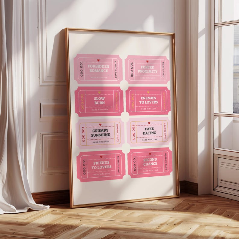 May include: A framed print featuring eight pink love coupons with phrases like "Forbidden Romance" and "Fake Dating." The coupons have a vintage design with rounded corners and the text "Made with Love." The frame is gold.