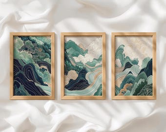 May include: A set of three rectangular wall art prints in light wood frames. Each print features a landscape illustration with layered mountains, rolling hills, and stylized clouds in shades of teal, dark blue, cream, and muted green.