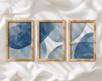 May include: Three rectangular wall art prints in light wood frames. Each print features a white background with overlapping circular shapes in shades of blue, characterized by fine, dense, hand-drawn line textures and soft watercolor washes.