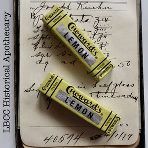 May include: Two yellow and white packages of Howard's Lemon 15 Mints chewing gum. The packages are on a page of a vintage medical journal with handwritten notes.