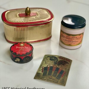 May include: An assortment of vintage apothecary items, including a gold and red container, a pink jar of "Flesh Vanishing Cream," and a small tin of "Princess Pat" powder. A "Hold-Bob" hair accessory card is also present.