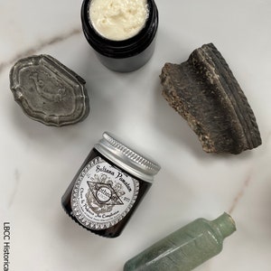 May include: A small glass jar with a silver lid containing a cream labeled "Sultana Pomatum 1/2 oz. Apothecary 1800. Cleans & Protects The Complexion. Made in England. Sweet Almond Oil, Rosewater, Beeswax"