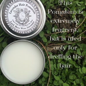 May include: A silver tin with a white label that reads "Lavender Hair Pomatum" and lists the ingredients as "Lard, Bees Wax, Lavender". The label also states "Used Only For Dreffing the Hair". The tin is sitting on a bed of green leaves. The text "This Pomatum is extremely fragrant, but is ufed only for dreffing the hair" is superimposed on the image. The text "WWW.LITTLEBITS.ETSY.COM LBCC HISTORICAL" is at the bottom of the image.