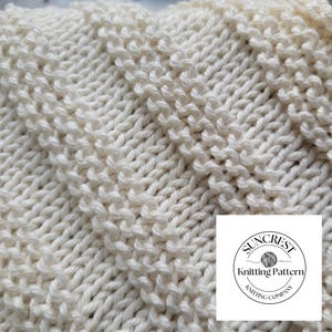 May include: Close-up of a white knitted fabric with a textured diamond pattern. The fabric is soft and fluffy. The image includes a logo for "Suncrest Knitting Pattern Company".