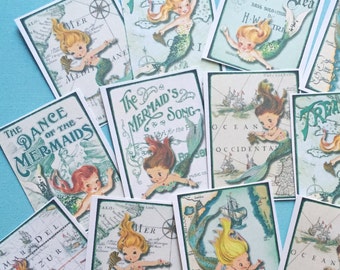 May include: A collection of vintage mermaid-themed cards with illustrations of mermaids, ships, and ocean scenes. The cards feature titles like "The Dance of the Mermaids", "Treasure", and "As Deep As The Deep Blue Sea".