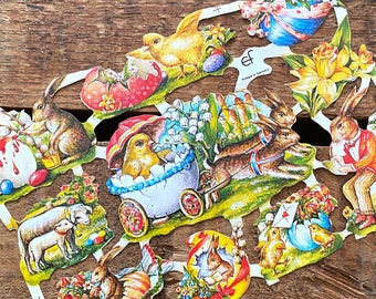 May include: A colorful paper craft set featuring Easter-themed illustrations. The set includes images of bunnies, chicks, eggs, flowers, and a wagon. The paper is printed with a vintage style design.