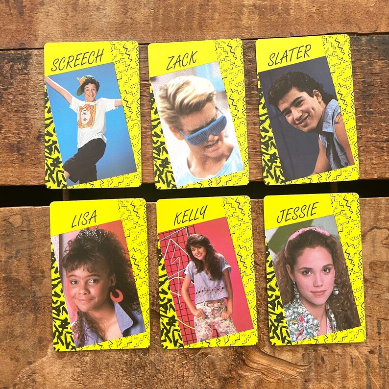 May include: Six vintage trading cards featuring images of characters from a television show. Each card has a yellow border with a black zigzag design and a photo of a character. The character names are printed in yellow.
