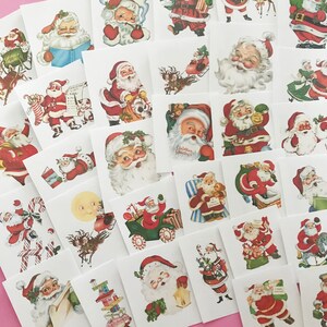 May include: A sheet of vintage Christmas stickers featuring various illustrations of Santa Claus in different poses and settings. The stickers are printed on white paper with a red border.