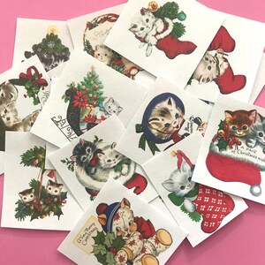 May include: A collection of vintage Christmas cards featuring kittens in various holiday scenes. The cards are printed on white paper with red and green accents. Some of the cards feature kittens wearing Santa hats, others feature kittens in stockings, and others feature kittens with Christmas trees. The cards are all in good condition and would make a great addition to any Christmas collection.