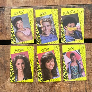 May include: Six vintage trading cards featuring cast members from a popular 1990s television show. Each card has a yellow border with a zig-zag design and a photo of a character with their name printed at the top. The characters are Slater, Zack, Screech, Jessie, Kelly, and Lisa.