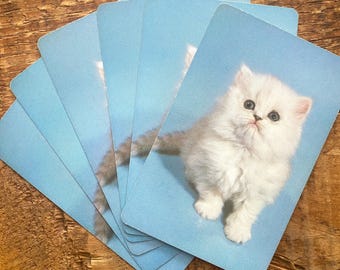 Juego de 6 cartas con gatitos blancos vintage sobre fondo azul.