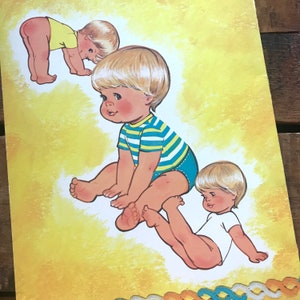 May include: Three illustrations of babies with blonde hair. The baby on the left is standing and wearing a yellow shirt. The baby in the middle is sitting and wearing a blue and yellow striped shirt. The baby on the right is lying on its back and wearing a white shirt.
