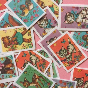 May include: A collection of vintage animal trading cards featuring kittens, a deer, a squirrel, and a teddy bear. The cards have a colorful background with flowers and butterflies.