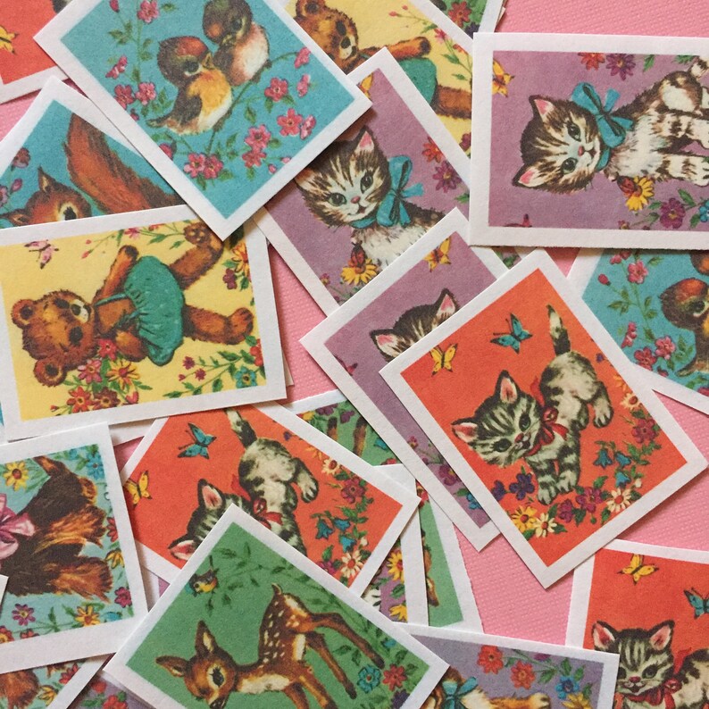 May include: A collection of vintage animal trading cards featuring kittens, a deer, a squirrel, and a teddy bear. The cards have a colorful background with flowers and butterflies.
