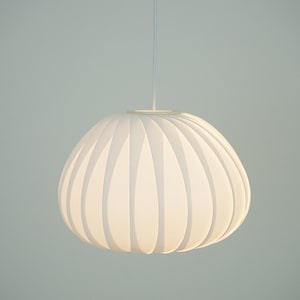 May include: A white pendant light with a rounded, ribbed shade. The shade has a soft, glowing appearance, and is suspended from a single cord. The light fixture is a modern design, suitable for interior lighting.