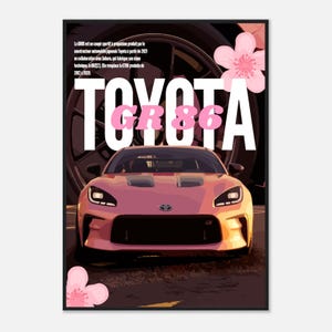 以下が含まれることがあります： ピンク色のトヨタ GR86 スポーツクーペのポスター。車が中央に配置されています。「TOYOTA」の文字が白とピンクで「GR86」の上にあります。隅には桜の花があります。フランス語で車の生産について説明するテキスト。