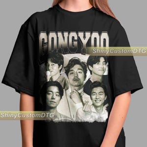 May include: Black t-shirt featuring a vintage-style graphic of the name "GONGYOO" above a collage of five grayscale portraits of a man. The text "ShinyCustomDTG" is printed on the shirt.