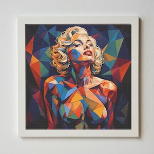 May include: A framed, colorful geometric portrait of a woman with blonde hair, looking upwards. The artwork features a mosaic-like design with shades of blue, orange, and yellow. The background is a dark geometric pattern.