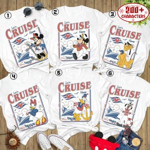six white t-shirts with Disney-themed designs, including characters like Mickey Mouse, Donald Duck, and Goofy, along with the text "Let's Cruise" and "Disney Wonder". The t-shirts are arranged in a grid, with each row containing three shirts. The t-shirts are displayed on a wooden surface, and there are some sunglasses and a pair of sneakers visible in the image.