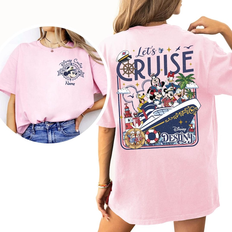 A woman wearing a pink t-shirt with a Disney Cruise-themed design, including Mickey Mouse and Minnie Mouse characters on a cruise ship.