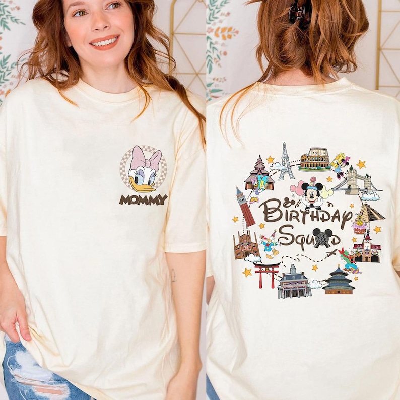 A woman wearing a white t-shirt with a cartoon character and text printed on it.