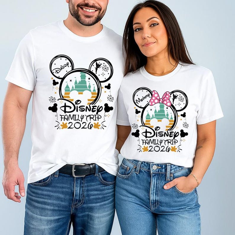 A man and a woman are standing next to each other, both wearing white t-shirts with Disney-themed designs.