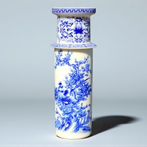 May include: A tall, cylindrical ceramic vase with a cream base and a blue and white floral design. The vase has a decorative top with a repeating pattern. The design includes birds and flowers.