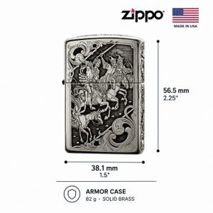 May include: A silver-toned Zippo Armor Case lighter featuring an intricate engraved scene of figures on horseback with swords. The lighter measures 2.25 inches in height and 1.5 inches in width, weighing 82 grams. It is made of solid brass.