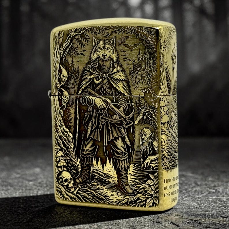 May include: A gold-colored metal lighter with an engraved design. The design features a wolf-like figure in a cloak holding a crossbow, surrounded by trees, a castle, and other fantasy elements. The lighter has a rectangular shape.