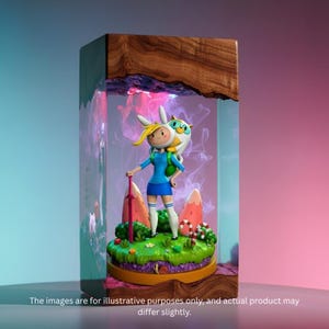 May include: A resin art piece featuring a cartoon character in a blue dress and white socks, holding a red sword. The figure stands on a green base with candy and mountain details, encased in a clear resin block with a wooden top. The text at the bottom reads: "The images are for illustrative purposes only, and actual product may differ slightly."